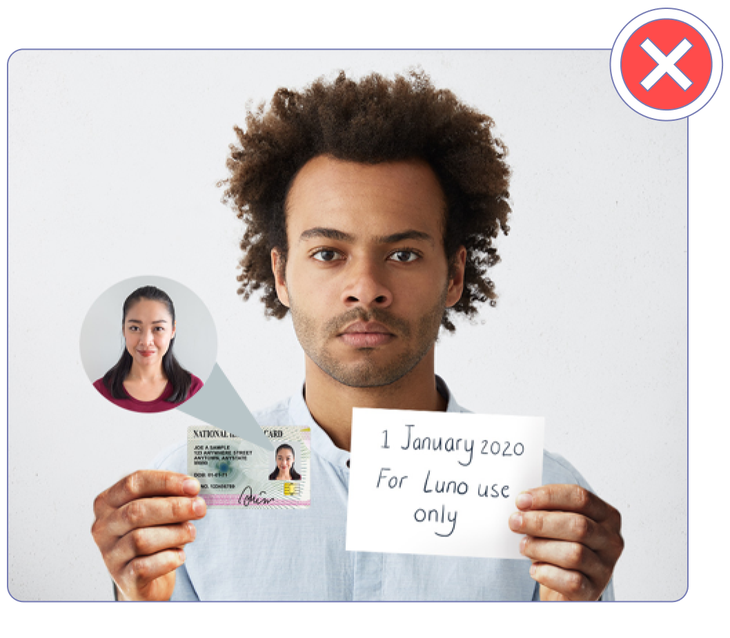 A photo of someone holding up an ID card belonging to someone else